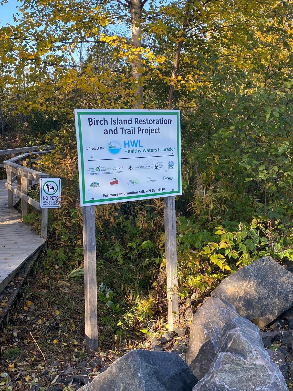 Birch Island Restoration and Trail Project sign along a scenic hiking trail